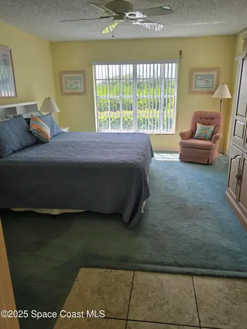 a bedroom with a bed and glass door