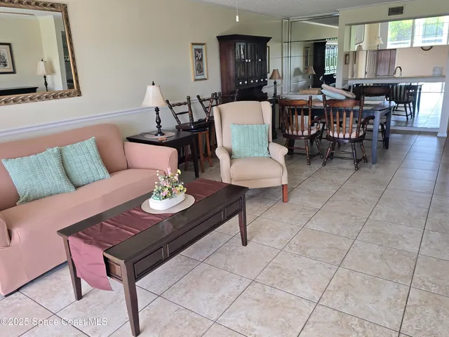 a living room with furniture a dining table and a dining table