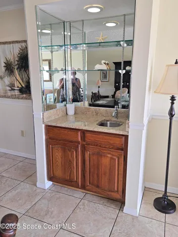 a bathroom with a granite countertop sink a mirror and shower