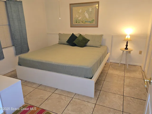 a bedroom with a bed and a shower