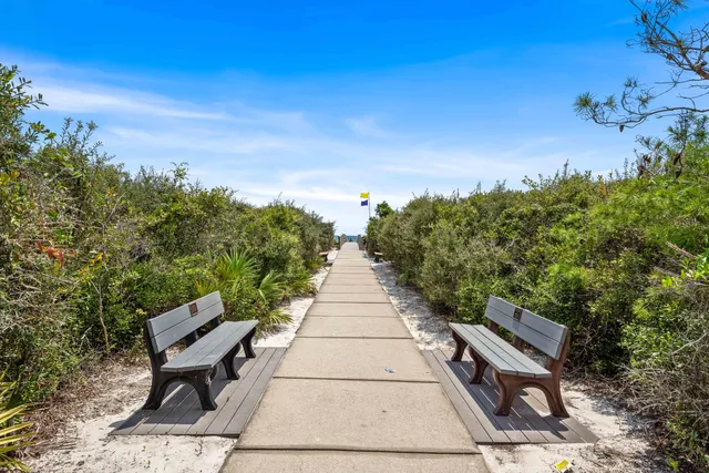 a park view with a bench in front of a house