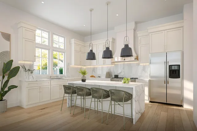 a kitchen with kitchen island granite countertop a sink and a refrigerator