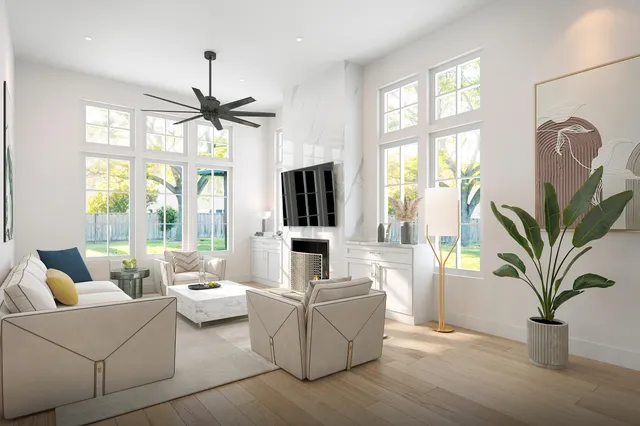 a living room with furniture fireplace and a large window