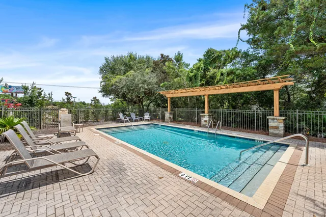 a view of a house with swimming pool and sitting area