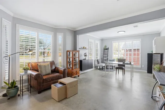 a living room with furniture and a dining table with kitchen view