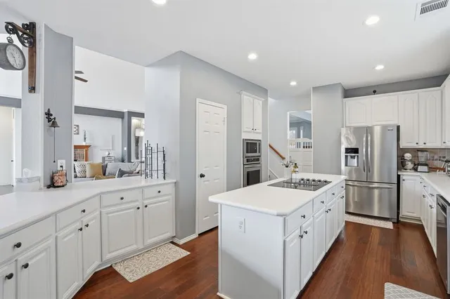 a kitchen with white cabinets and white appliances