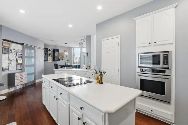 a kitchen with stainless steel appliances granite countertop a sink and dishwasher a stove with wooden floor