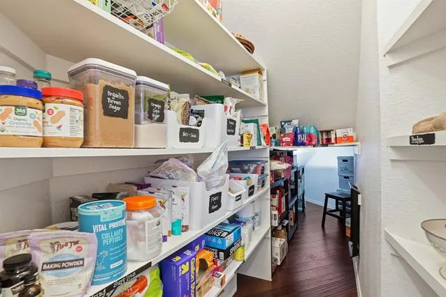 a utility room with fridge dryer and bicycles
