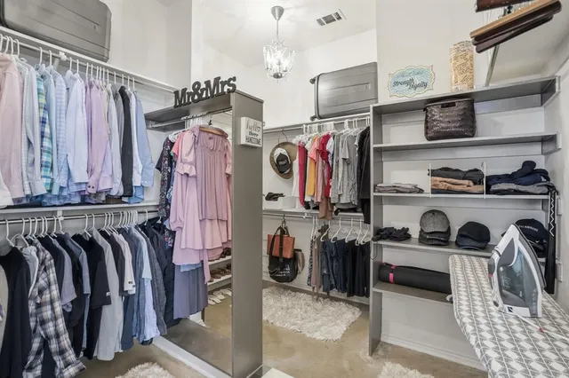 a view of walk in closet with clothes and shoes