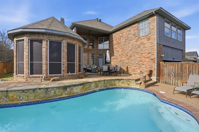 a view of a house with swimming pool and sitting area