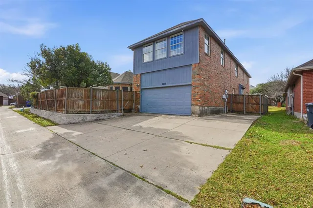 a view of backyard of house along with trees