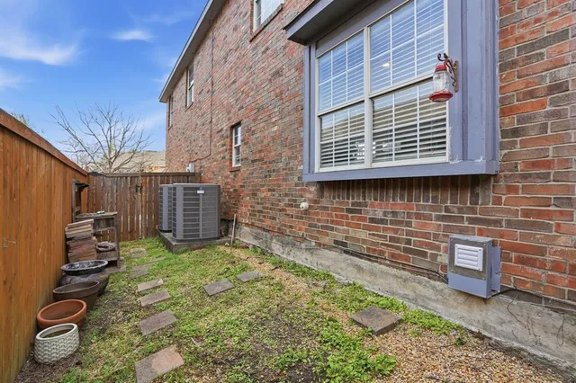 a view of a backyard with brick wall