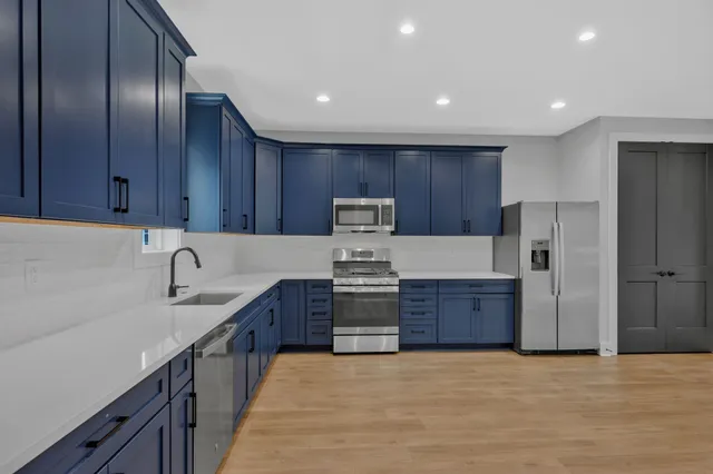 a kitchen with granite countertop wooden cabinets and stainless steel appliances