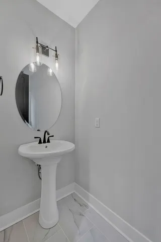 a bathroom with a sink and mirror
