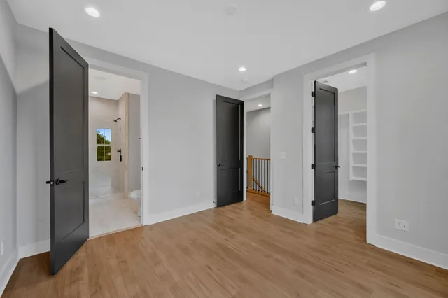 a view of a bedroom with wooden floor and closet