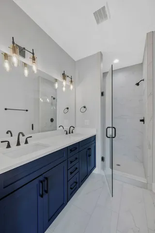 a spacious bathroom with a granite countertop sink mirror and shower
