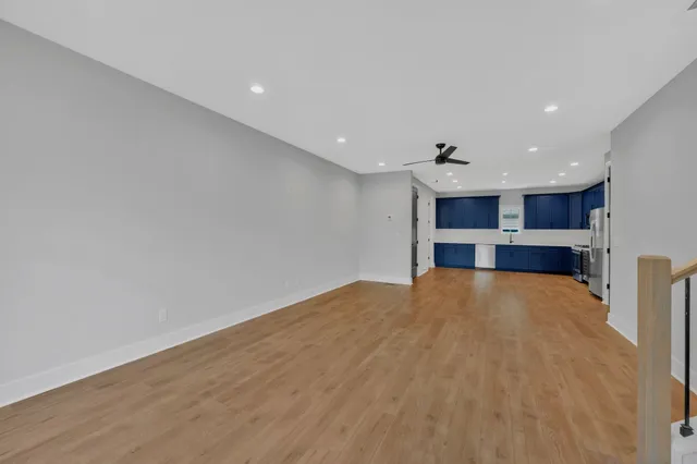 a view of empty room with a kitchen