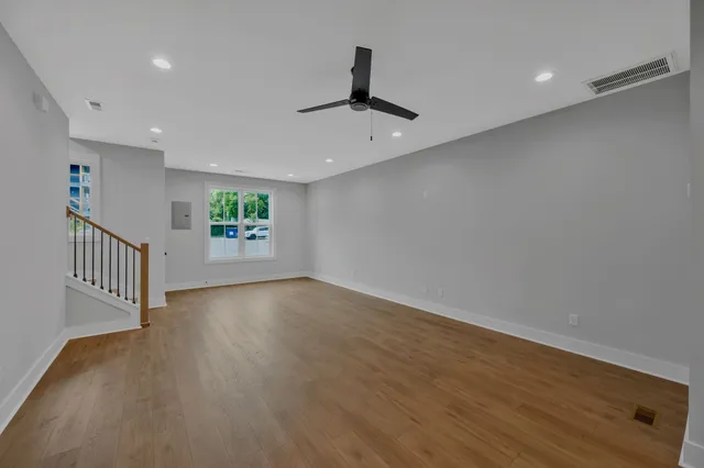 wooden floor in an empty room with a window