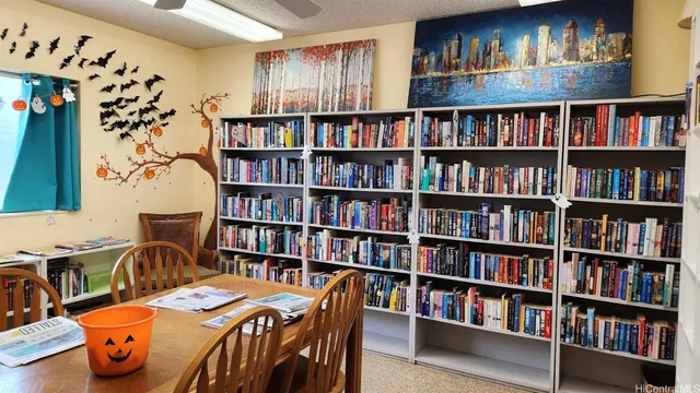 a view of a dining room with furniture and a book shelf