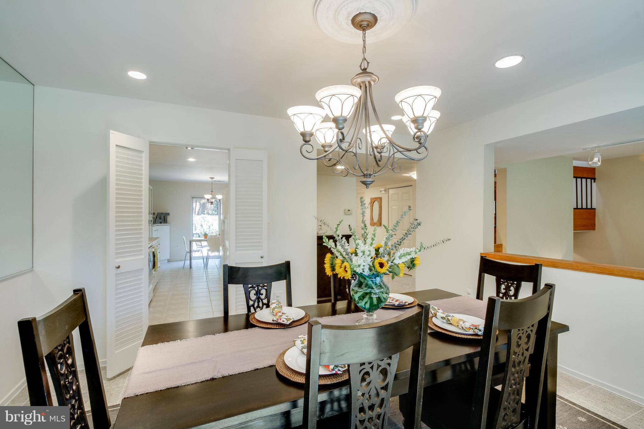 11729 Indian Ridge Road Reston, VA 20191 - Photo 12 of 30 a view of a dining room with furniture and chandelier