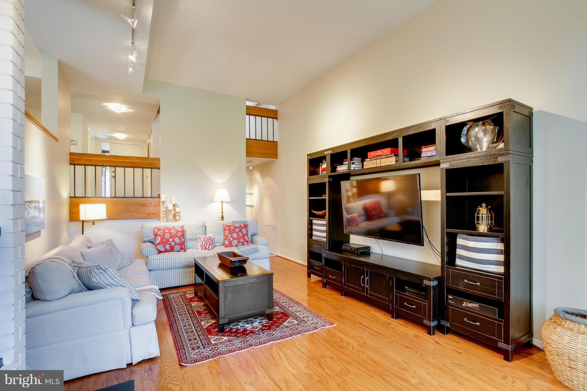 11729 Indian Ridge Road Reston, VA 20191 - Photo 15 of 30 a living room with furniture and a flat screen tv