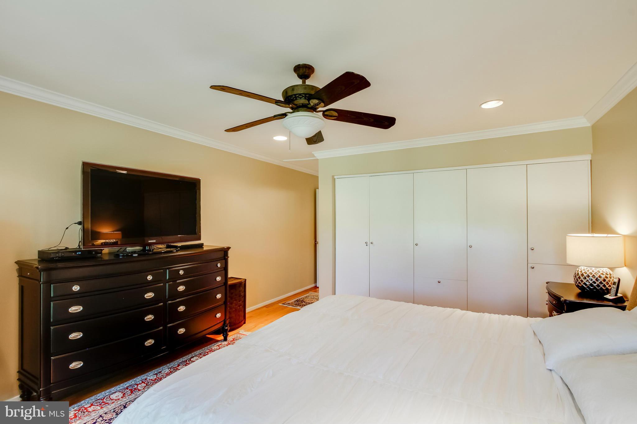 11729 Indian Ridge Road Reston, VA 20191 - Photo 18 of 30 a bedroom with a bed and a flat screen tv