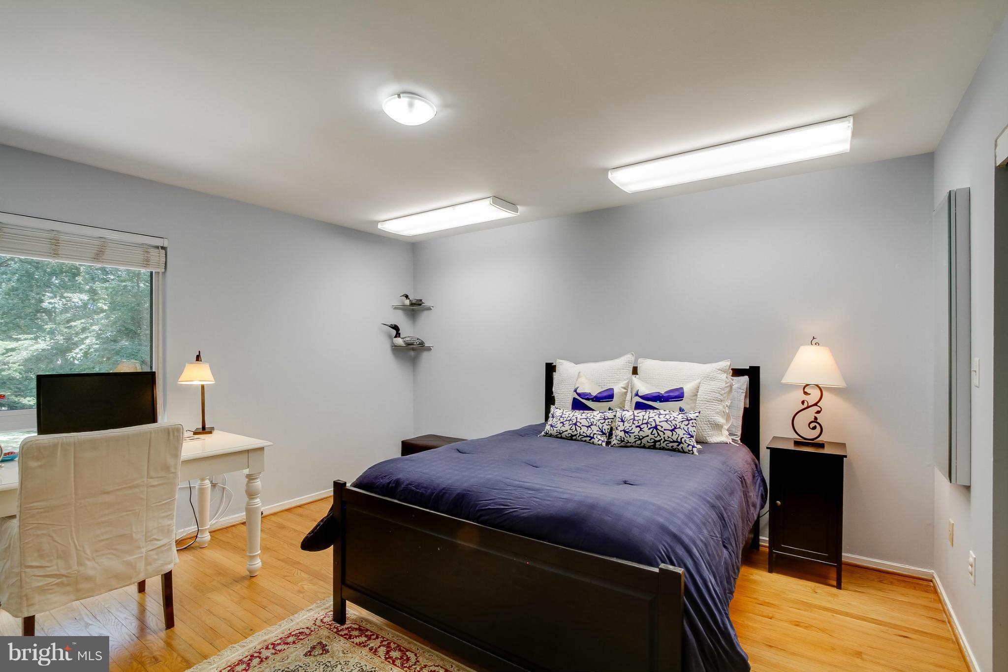 11729 Indian Ridge Road Reston, VA 20191 - Photo 21 of 30 a bedroom with a bed and wooden floor