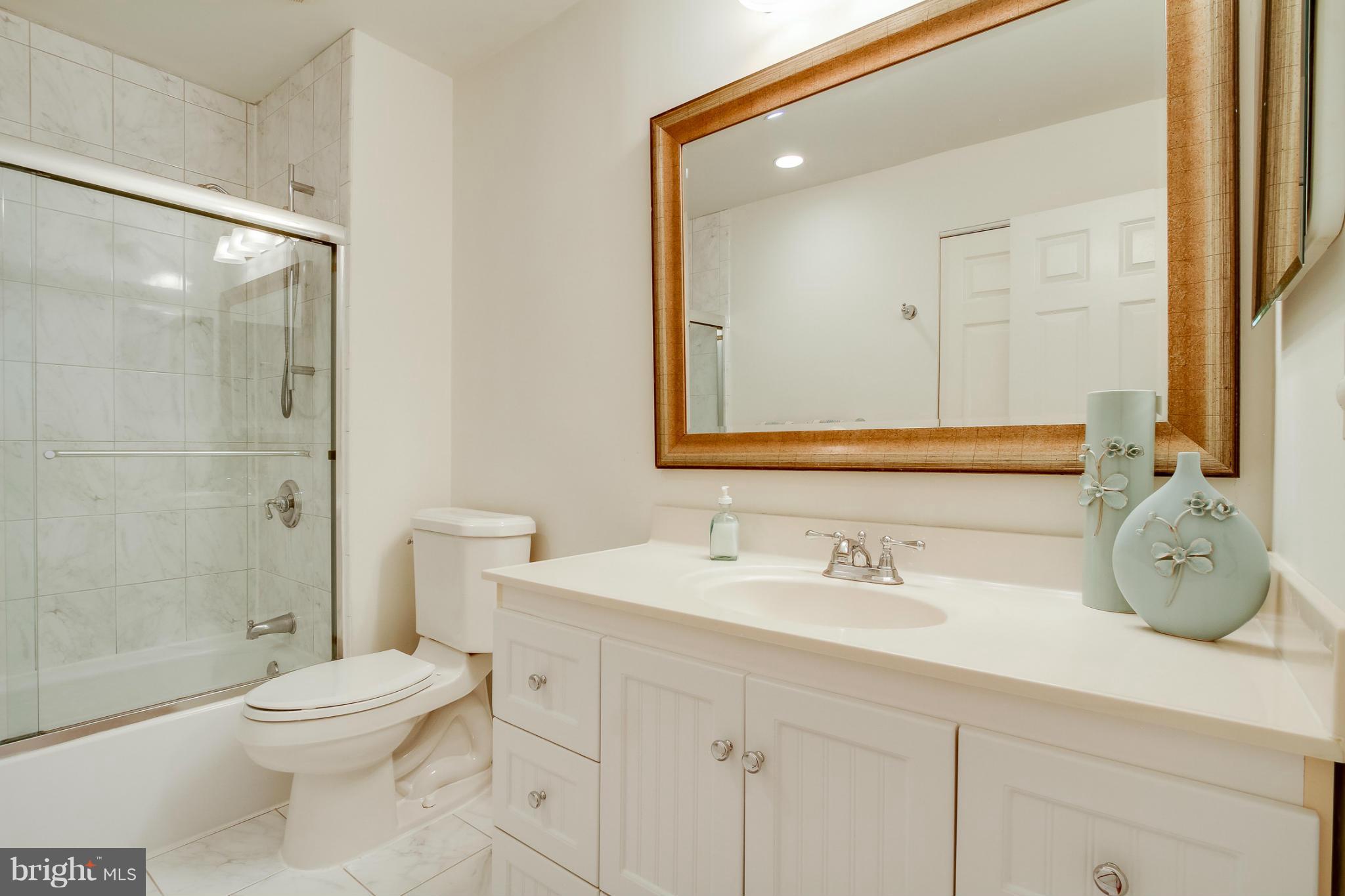 11729 Indian Ridge Road Reston, VA 20191 - Photo 22 of 30 a bathroom with a sink a toilet and shower