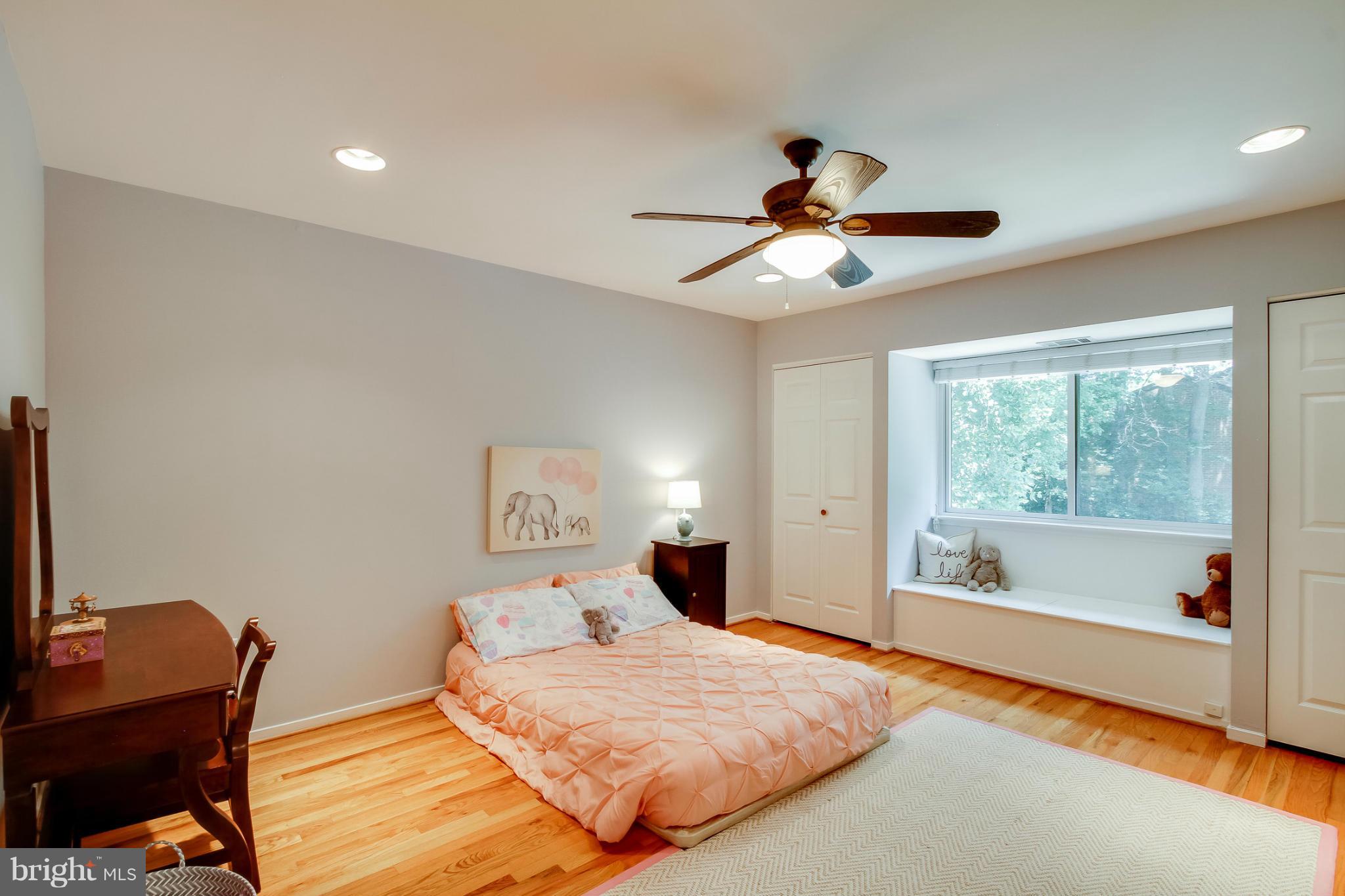 11729 Indian Ridge Road Reston, VA 20191 - Photo 23 of 30 a bedroom with a bed and a chandelier