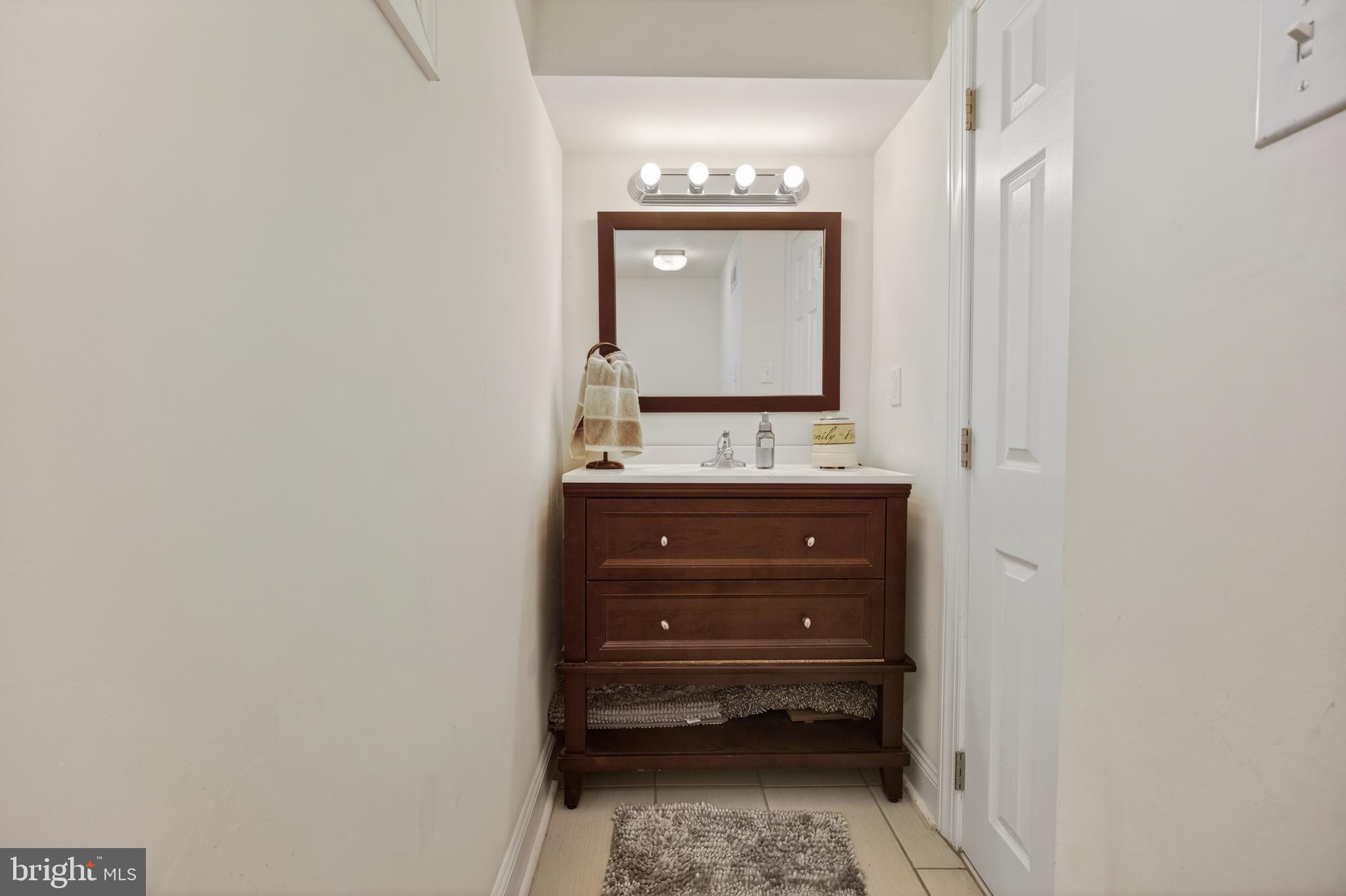 1123 Wynnbrook Road Secane, PA 19018 - Photo 11 of 14 a bathroom with a sink a mirror and cabinets