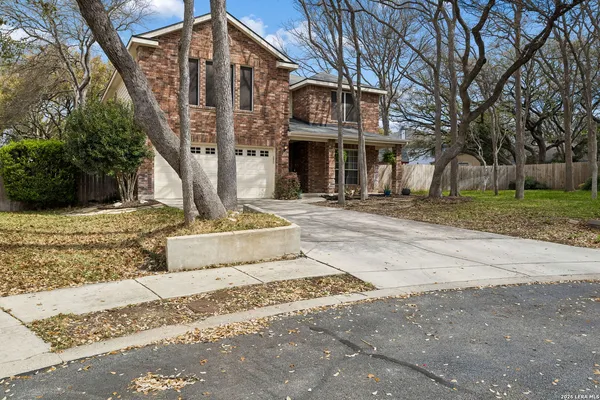 a front view of a building with trees