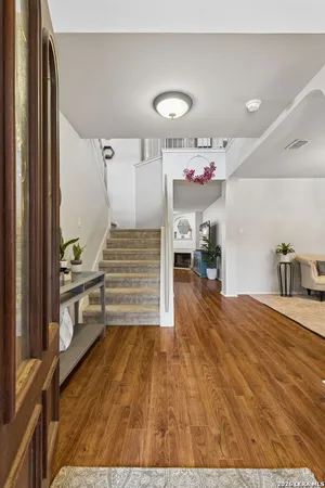 a view of a hallway view with staircase and kitchen view