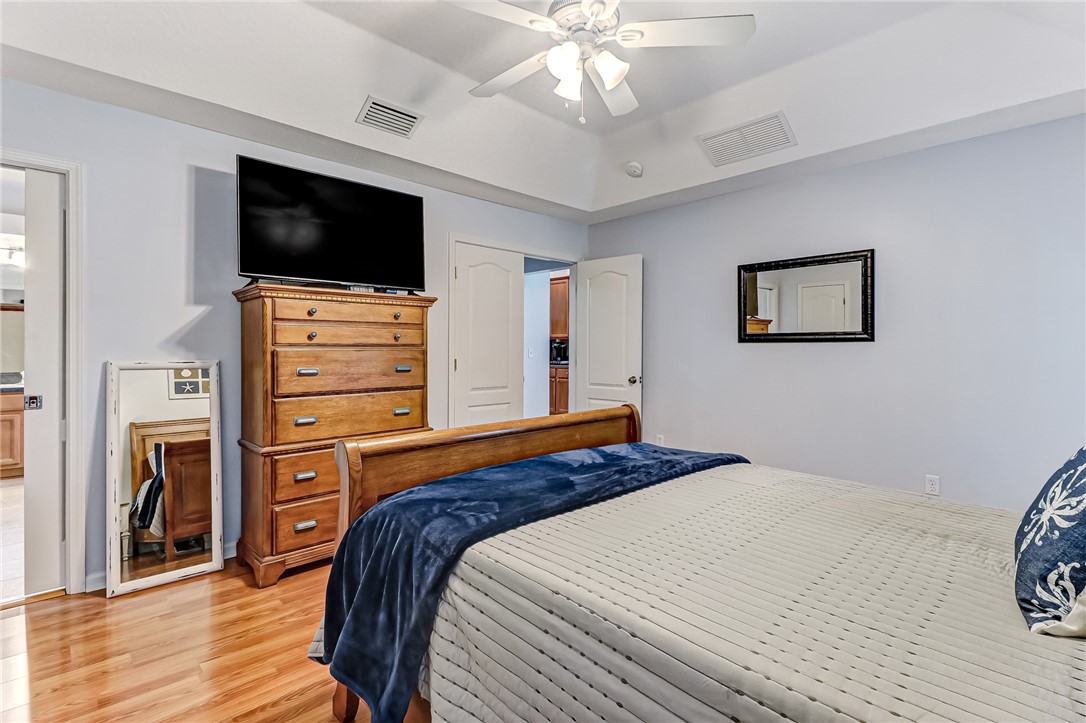 97017 Castle Ridge Drive Yulee, FL 32097 - Photo 16 of 31 a bedroom with a bed and a flat screen tv