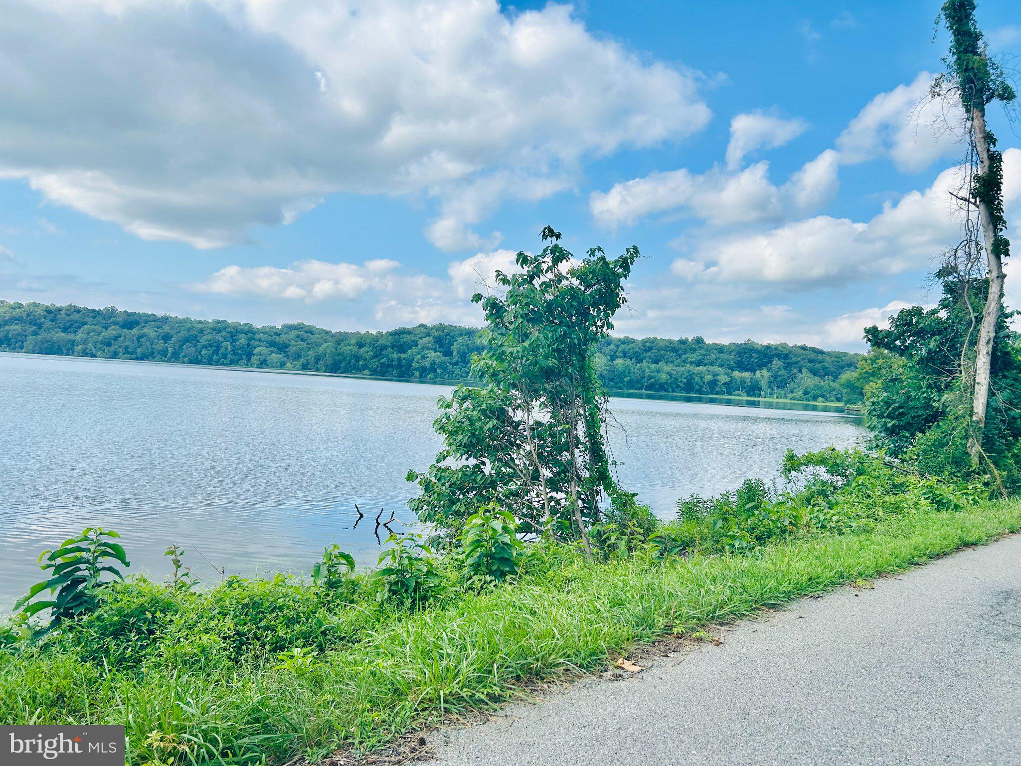 14500 Leonard Calvert Drive Accokeek, MD 20607 - Photo 9 of 18 Serene lakeside view under blue skies.