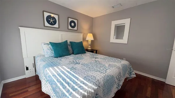a bedroom with a bed and a night stand