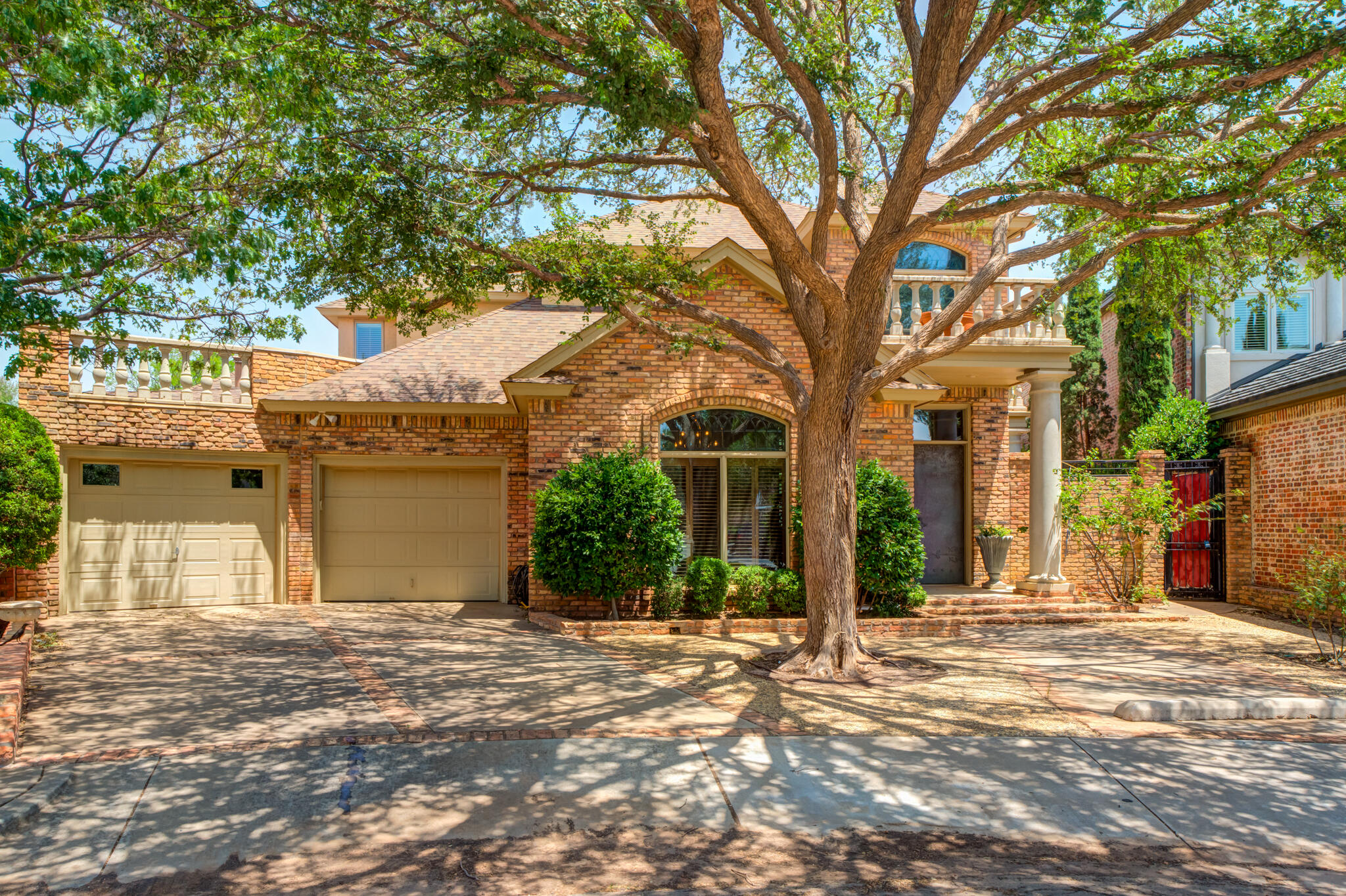 a front view of a house with a tree