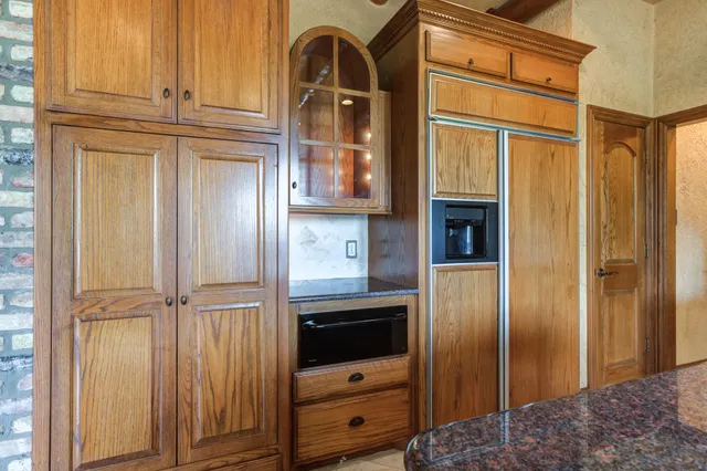 a kitchen with stainless steel appliances granite countertop a sink and a stove