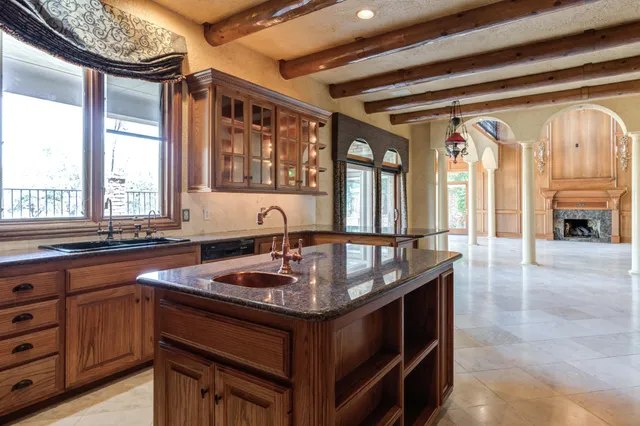 a view of a kitchen with a sink and large windows