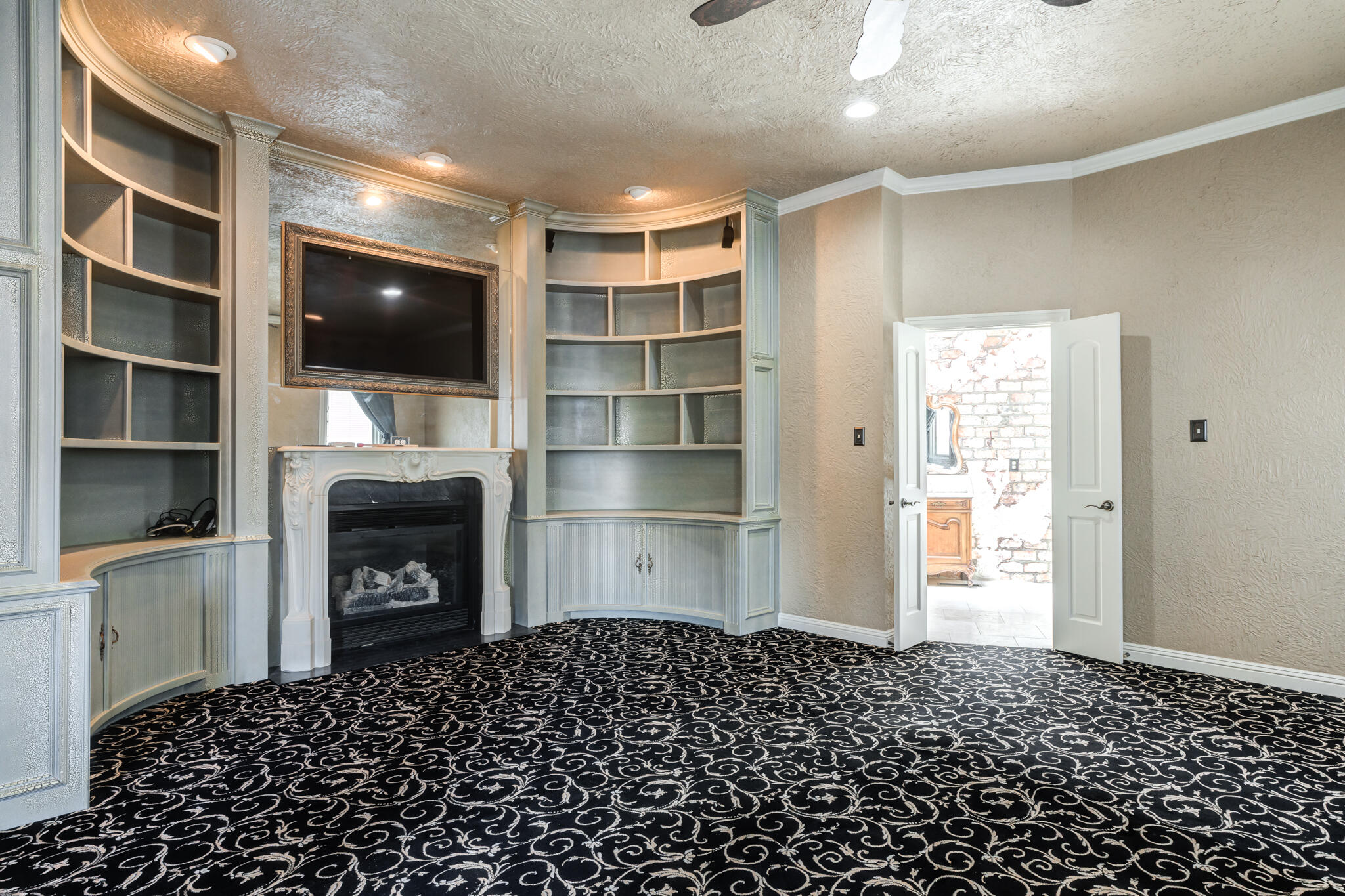 8901 York Place Lubbock, TX 79424 - Photo 22 of 45 a living room with a flat screen tv and a fireplace