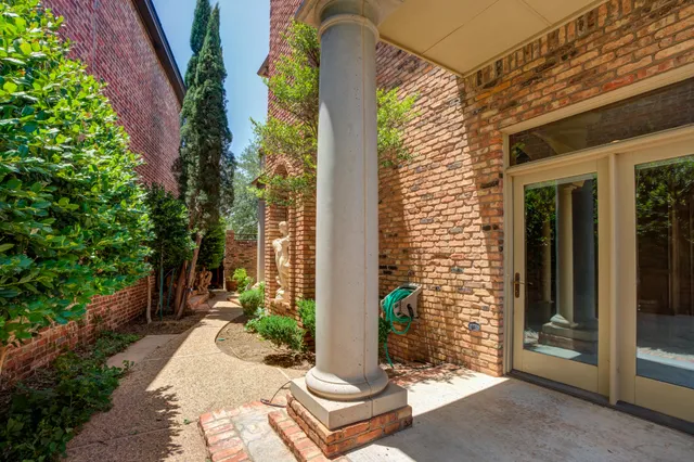 a view of backyard with plants and outdoor seating