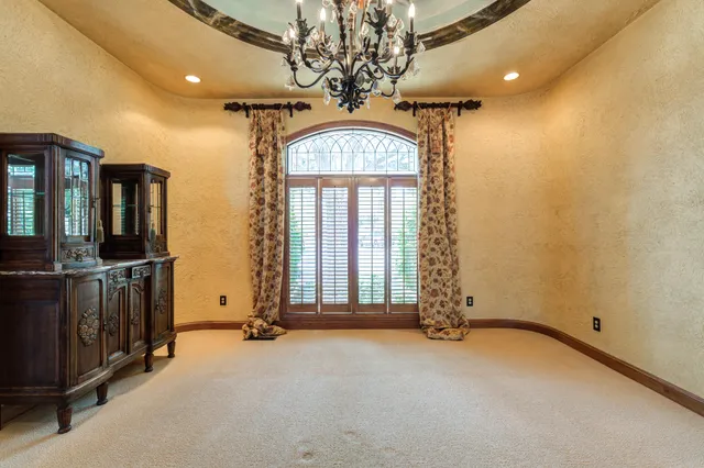 en view of a hallway with chandelier