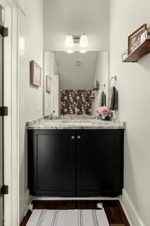 a bathroom with a granite countertop sink a toilet and a mirror