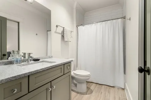 a living room with furniture a flat screen tv and a large window