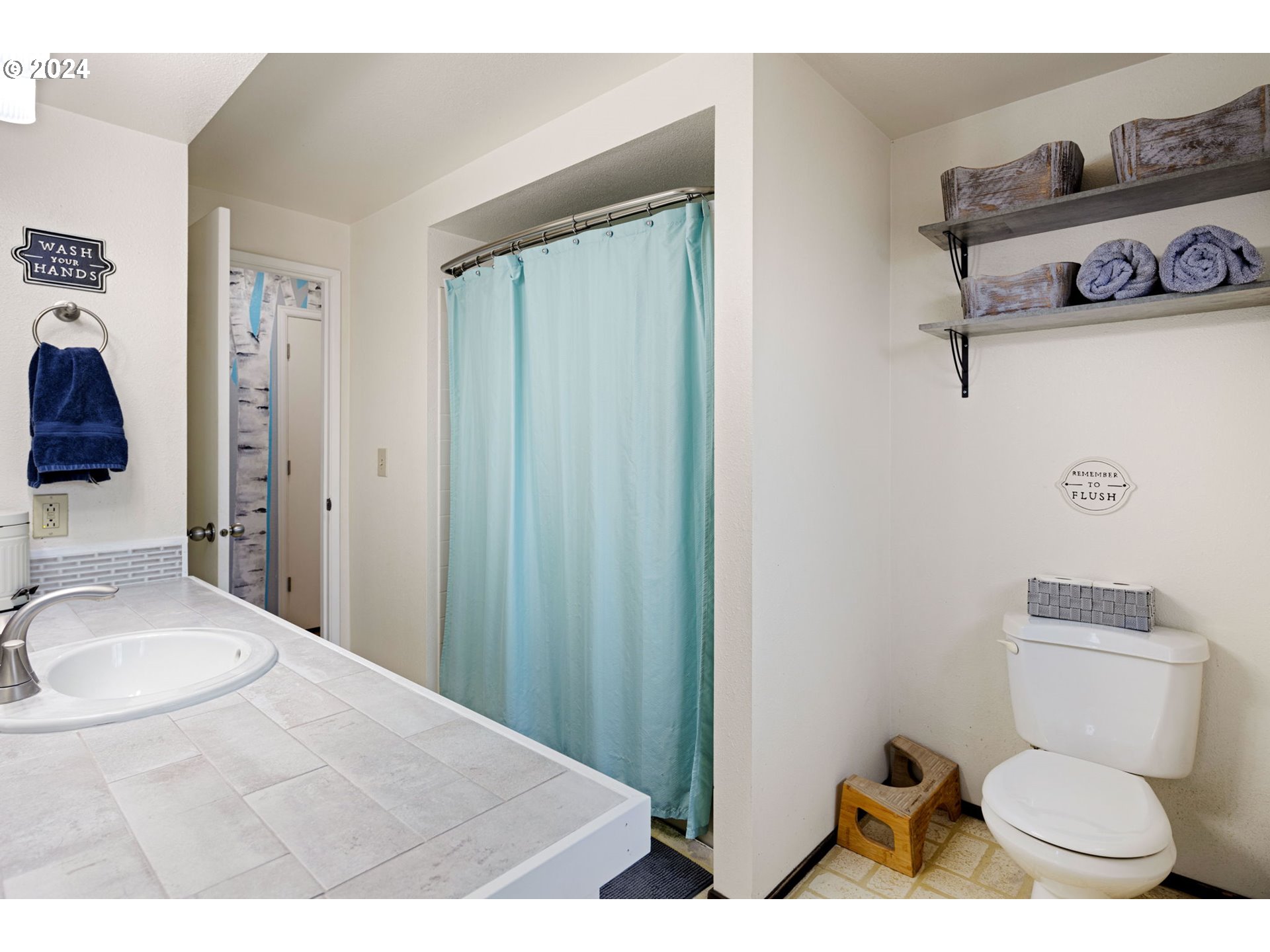 6926 B Street Springfield, OR 97478 - Photo 18 of 29 a bathroom with a toilet a sink and a mirror