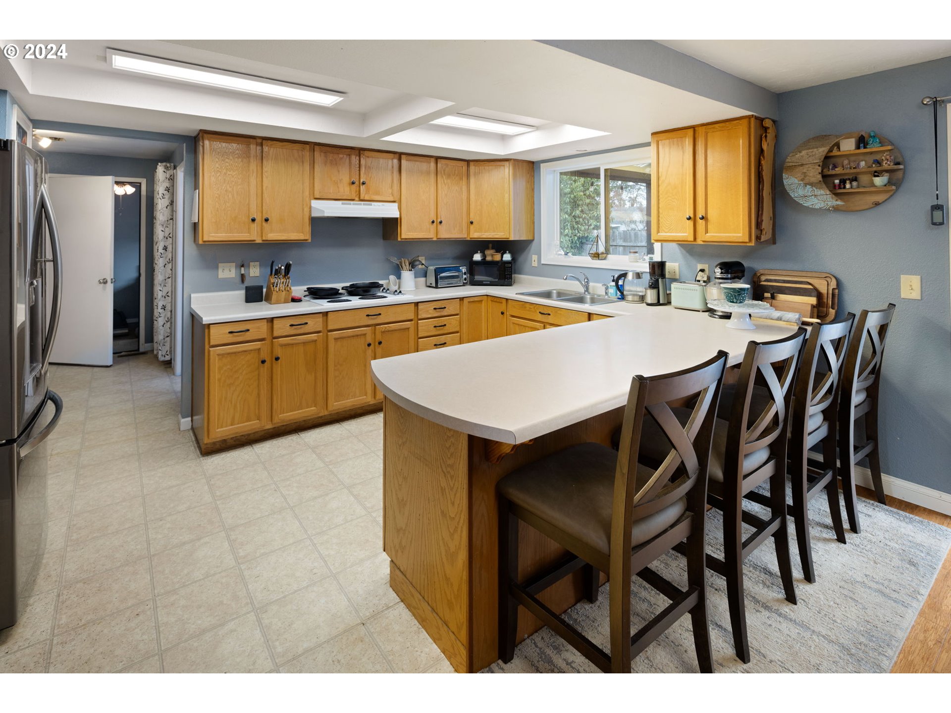 6926 B Street Springfield, OR 97478 - Photo 9 of 29 a kitchen with a table chairs sink and cabinets
