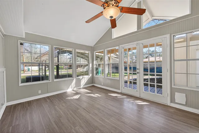 a living room with hardwood floor and balcony