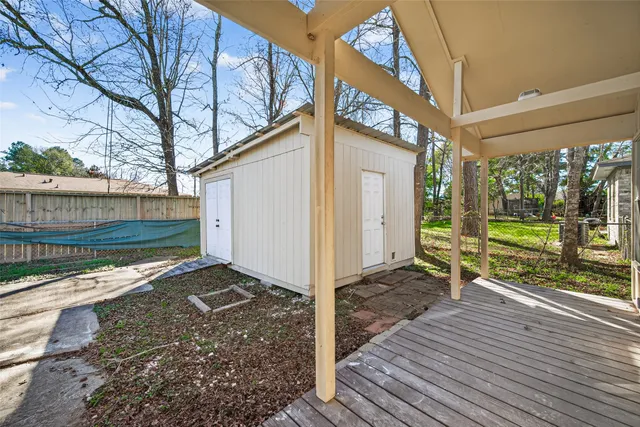 a view of a backyard with wooden fence