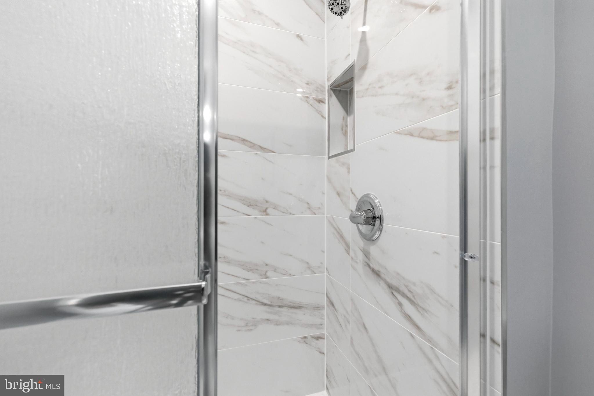 14400 Gunstock Court, Unit 4 Silver Spring, MD 20906 - Photo 42 of 47 Sleek marble shower with modern fixtures.