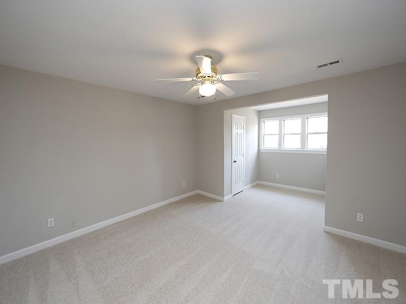 5919 Sentinel Drive Raleigh, NC 27609 - Photo 11 of 13 an empty room with a window and a ceiling fan