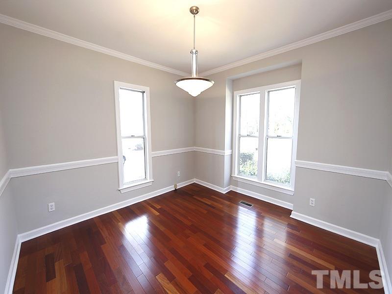 5919 Sentinel Drive Raleigh, NC 27609 - Photo 3 of 13 a view of an empty room with wooden floor and a window
